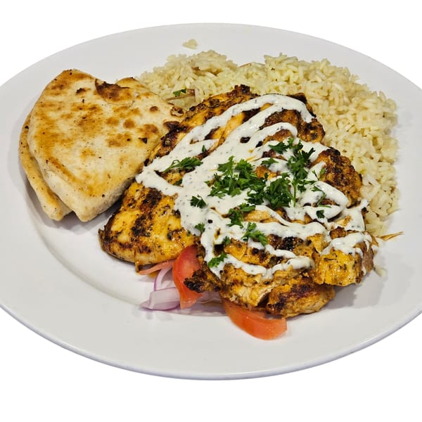 Grilled chicken with tzatziki, rice pilaf, and pita bread on a white plate at Firehouse Taverna.