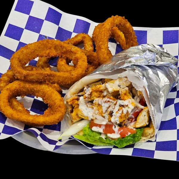 Chicken gyro with lettuce, tomato, onion, and tzatziki sauce, served with crispy onion rings.